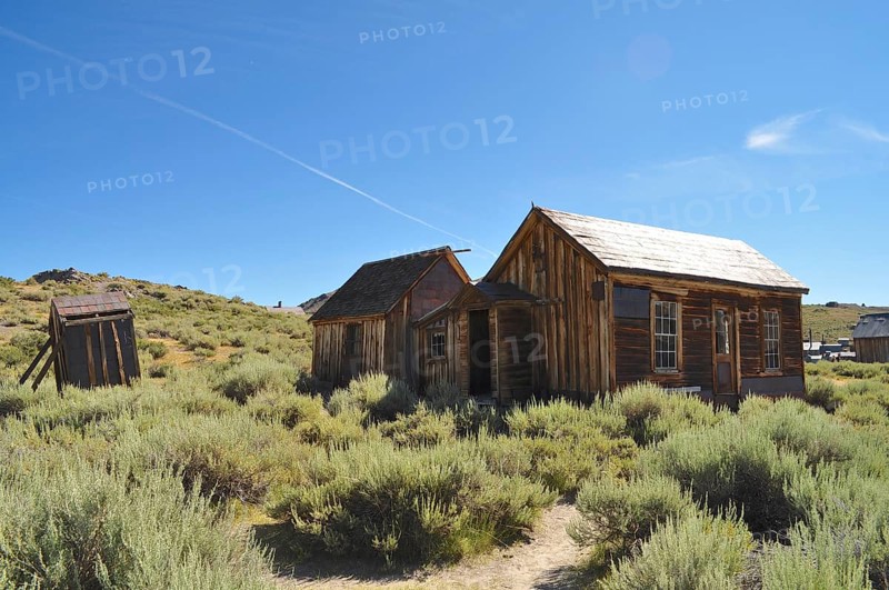 Abandoned wooden houses of a ghost town in dry vegetation, Bodie Ghost Town, California, USA