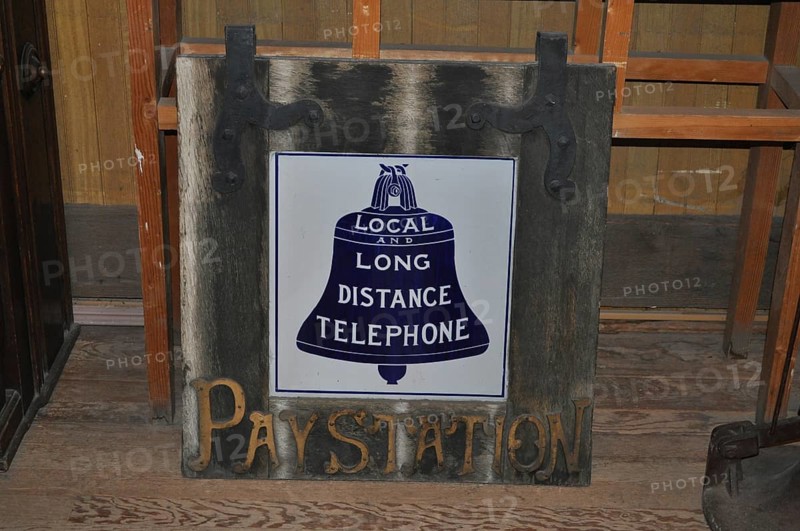 A historic telephone sign on a wooden board in an abandoned room, Bodie Ghost Town, California, USA