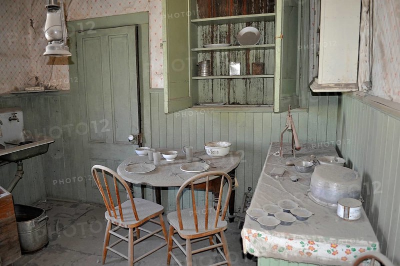 Dusty kitchen, vintage kitchen with old dishes and furniture in an abandoned setting, Bodie Ghost Town, California, USA