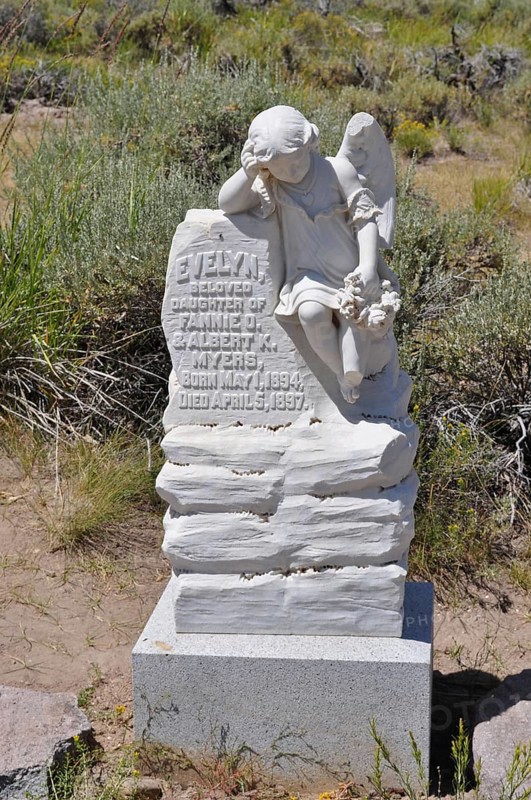 White angel statue on a tombstone of a children's grave from 1897, in a rural area, Bodie Ghost Town, California, USA