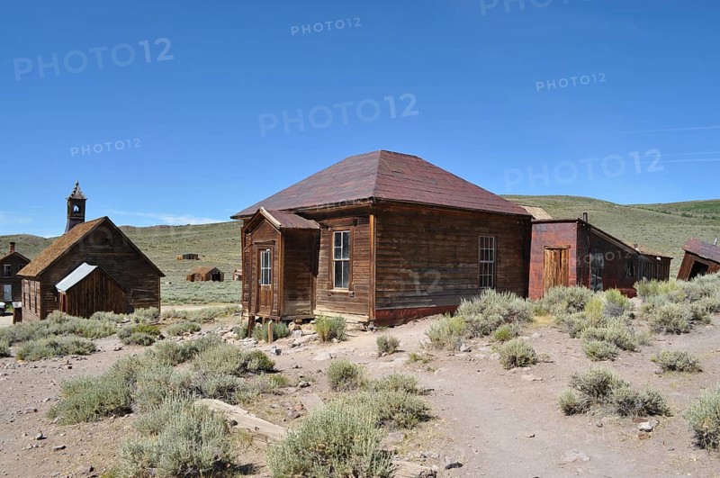 Abandoned wooden houses in the middle of a sandy and dry landscape, Bodie Ghost Town, California, USA