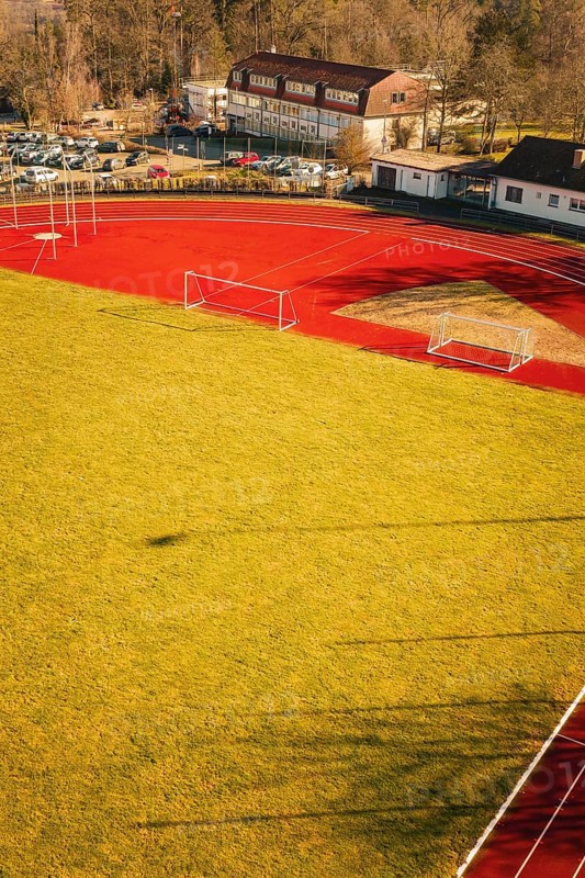 Close-up of a sports field with running track and shade on the grass, Wimberg, Calw, Germany