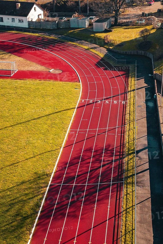 Close view of a red track with numbered tracks and cast shadows, Wimberg, Calw, Germany