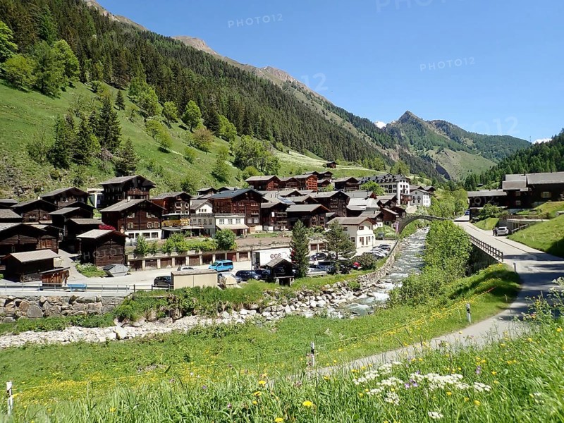 Alpine village with traditional architecture, nestled in green mountains and dense forest, Binn, Binn Valley, Goms, Canton of Valais, Switzerland