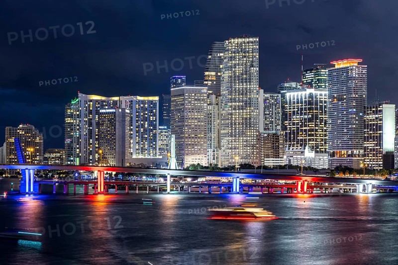 Miami skyline with high-rise real estate in downtown by the ocean at night in Miami, USA