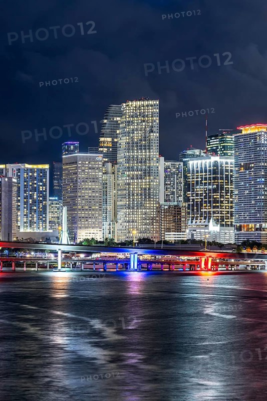 Miami skyline with high-rise real estate in downtown by the ocean at night in Miami, USA