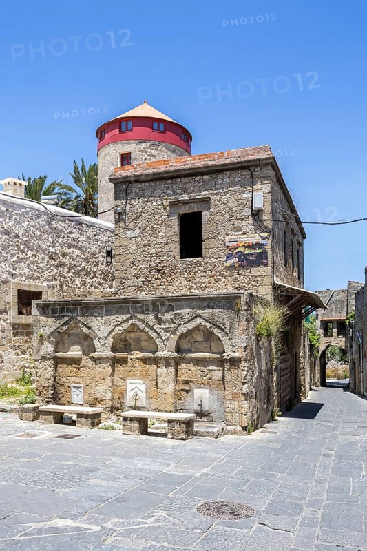 Ottoman fountain and windmill in the historic old town from the Middle Ages on the island of Rhodes, Greece