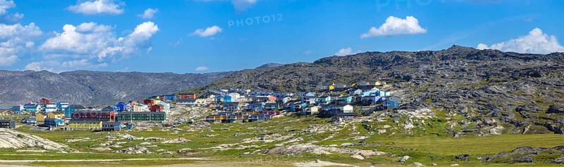 Typical architecture of Greenland Ilulissat with colored houses located near fjords and icebergs