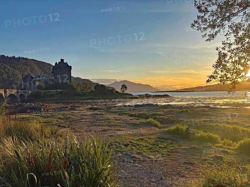 Castle in picturesque landscape at sunset with water and mountains, Highlander, film location, Dornie, Eilean Donan Castle, Scotland, Great Britain