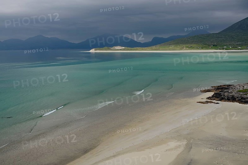 Wide sandy beaches under dark skies with calm seas and mountains, Outer Hebrides, Hebrides, Isle of Harris, Scotland, Great Britain