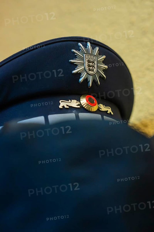 Police cap with badge in blue fabric viewed from close