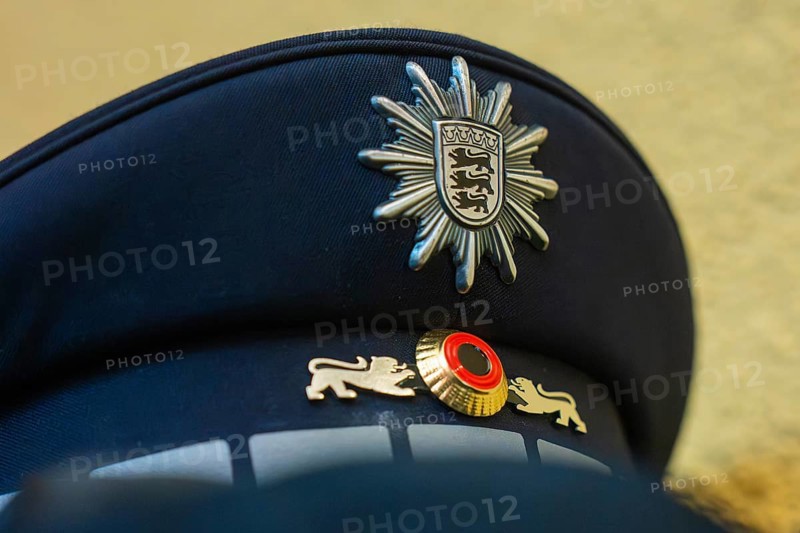 Close-up of a police cap with crest and blue fabric