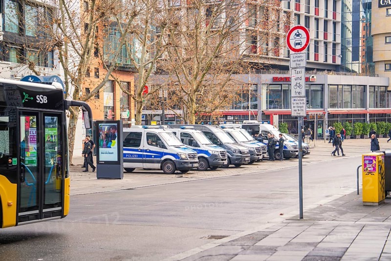 Urban scene with police car, bus and road signs on a cold day