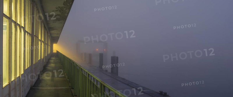 View along a long balcony of Steubenhöft of the ferry dock at Lübbenkai in fog, Cuxhaven, Lower Saxony, Germany