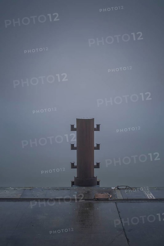 View of a bollard on the quay in fog, Cuxhaven, Lower Saxony, Germany