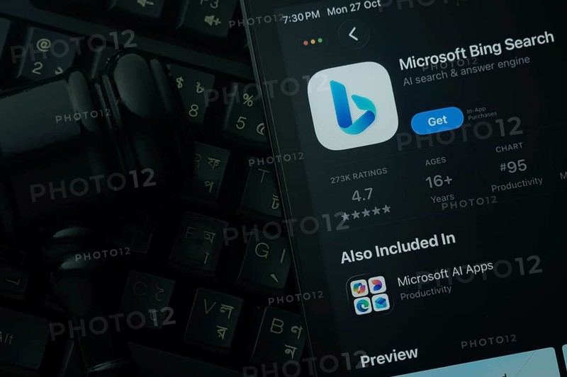 Dhaka, Bangladesh- 28 Oct 2025: An iPad displaying the Microsoft Bing app against a judge's gavel and dark keyboard background