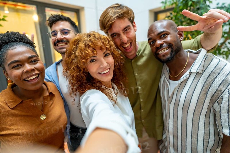 Happy business colleagues enjoying teamwork and a moment together, depicting diversity and collaboration in a modern office or coworking space during a break