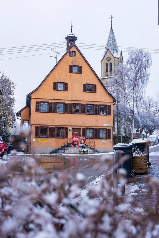Historic building. Old town hall and church in the snow, typical traditional village architecture, Gechingen, Calw district, Germany