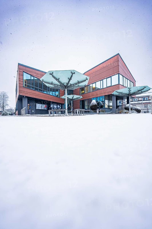 Modern town hall, predominantly glazed building in snowy, wintry surroundings, Gechingen, Calw district, Germany