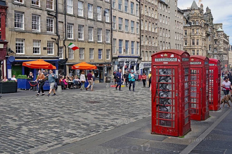Red telephone boxes on a busy street in front of old buildings, Royal Mile, Edinburgh, Scotland, United Kingdom