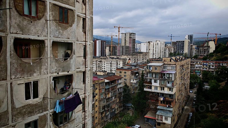 View of an urban landscape, residential district in Tbilisi with high-rise buildings and cranes, laundry hanging to dry on the balcony, Tbilisi, Georgia