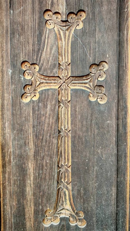 A detailed carved wooden cross on a wooden wall as decoration, Orthodox, Armenia