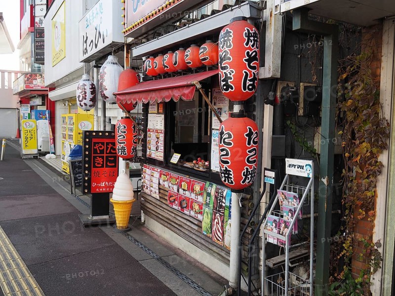 Small Japanese food stand with colorful lanterns on a street, Narita, Japan