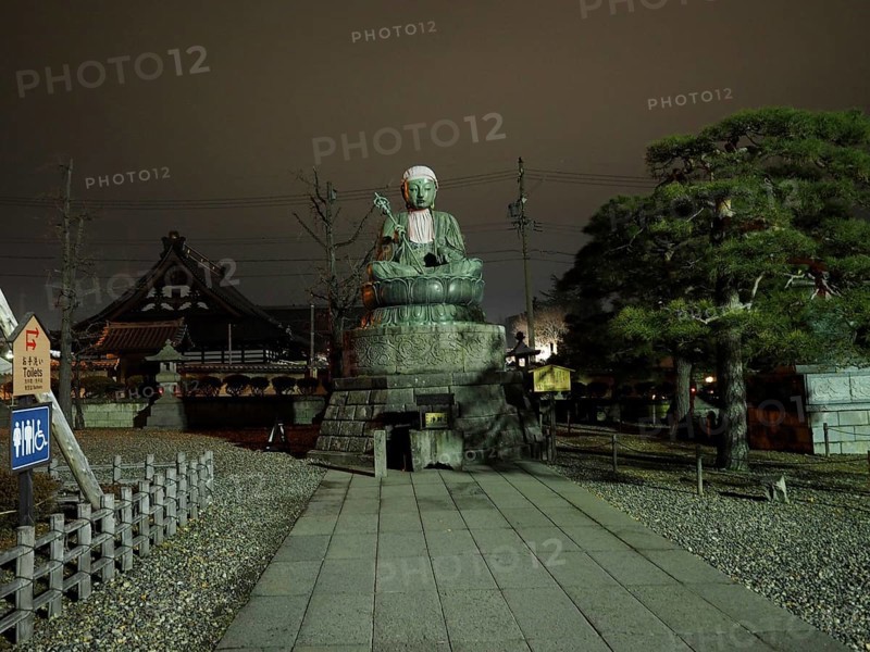 Large Buddha statue in front of a temple, calm atmosphere at night, Zenko-ji Temple, Nagano, Japan
