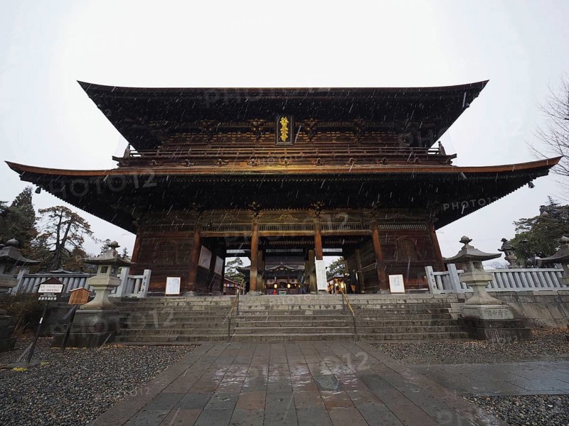 Large traditional temple in Japan, illuminated at night, majestic and impressive, Zenko-ji Temple, Nagano, Japan