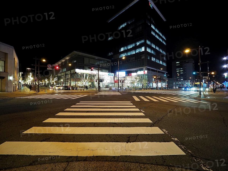 Modern buildings light up a nocturnal intersection full of lights, Chuo-dori Street, Nagano, Japan