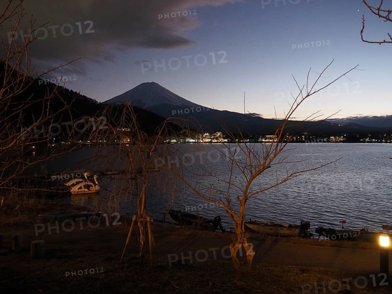 View of lake at night with Mount Fuji in the background and calm atmosphere, Lake Kawaguchiko, Japan