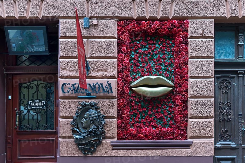 Bronze relief from Casanova, window with mouth and rose petals at Casanova restaurant, Lviv, Ukraine