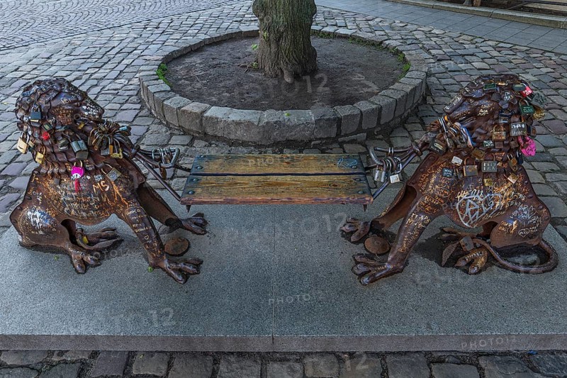 Lion figures with love locks holding a bench, Lviv, Ukraine