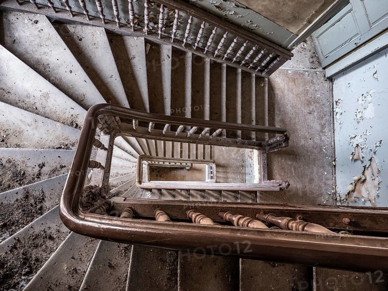 Staircase with wooden railing in a former sanatorium, Lost Place, Saxony-Anhalt, Germany