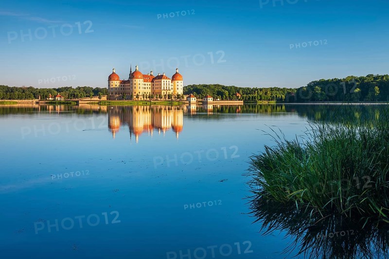 Moritzburg Castle, Augusts the Strong hunting lodge in morning light, water reflection in the lake, Saxony, Germany