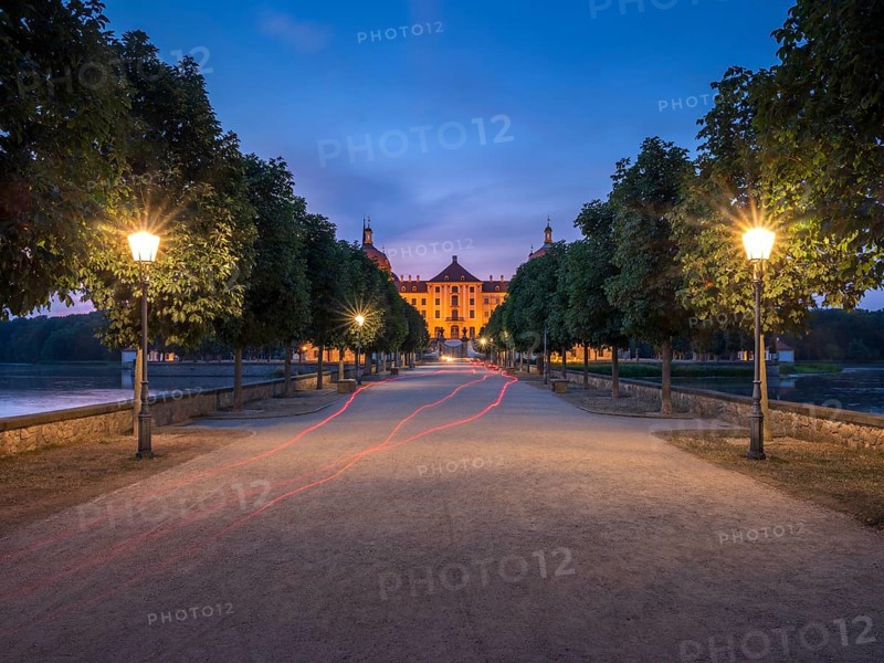 Avenue with lanterns as access to Moritzburg Castle, Augustus the Strong hunting lodge at dusk, Saxony, Germany