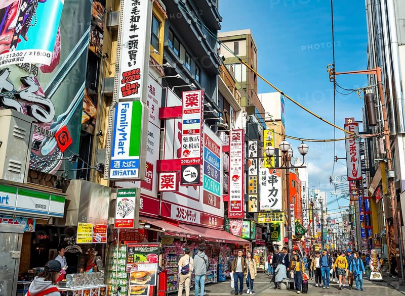 Lots of colorful signs in a pedestrian zone with shops and restaurants, Dotonbori, Osaka, Japan