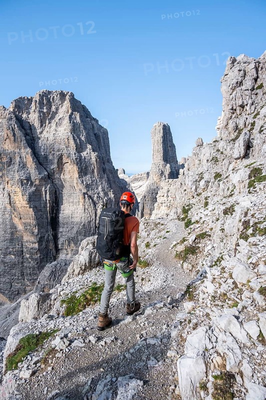 Climbers on a rock band, Bocchette Centrale band trail, via ferrata in the Brenta Mountains, Brenta-Adamello Natural Park, Trentino, Italy