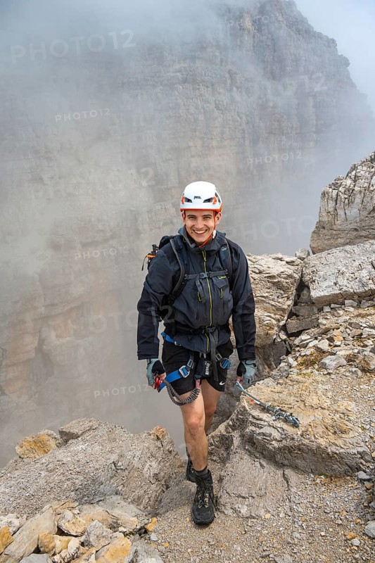 Happy mountaineer, Via Ferrata Oliva Detassis via ferrata in fog, rocky mountain peaks and mountain scenery, Brenta Mountains, Parco Naturale Brenta-Adamello, Trentino, Italy