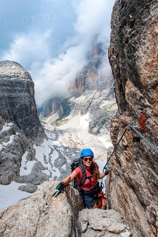 Climbers on the Via Ferrata Oliva Detassis via ferrata, rocky mountain peaks and mountain landscape, Brenta Mountains, Brenta-Adamello Natural Park, Trentino, Italy