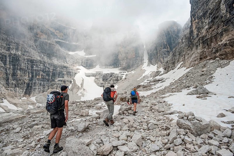 Hikers climbing the Via Ferrata Oliva Detassis, rocky mountain peaks and mountain scenery, Brenta Mountains, Brenta-Adamello Natural Park, Trentino, Italy