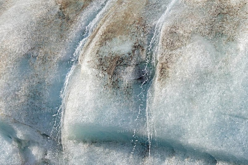 Water dripping from melting ice wall of Idabreen, Ida glacier calving into Liefdefjorden at Idabukta bay, Haakon VII Land, Spitsbergen, Svalbard