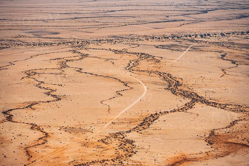 Extensive desert landscape with distinctive soil formations under clear skies, Spitzkoppe, Namibia