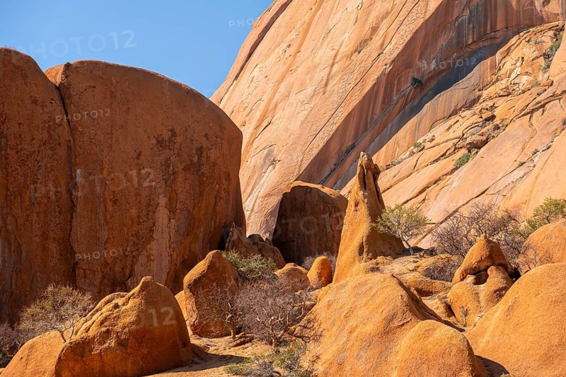 Elevated rock masses in warm tones under bright skies, Spitzkoppe, Namibia