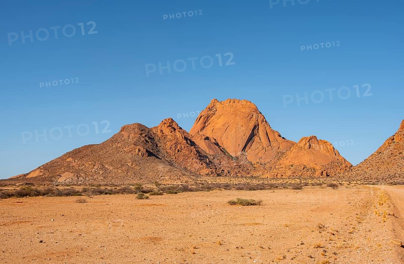 Wide desert landscape with distinctive orange mountains, Spitzkoppe, Namibia