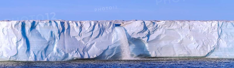 Waterfall at edge of Brasvellbreen glacier from the ice cap Austfonna pouring fresh water into the Barents Sea, Nordaustlandet, Svalbard / Spitsbergen
