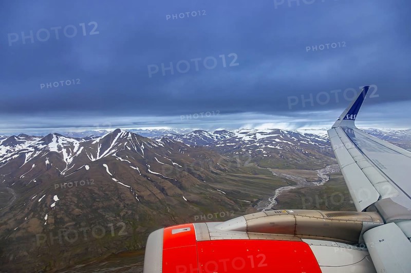 Airplane wing and aerial view over Adventdalen in summer, 30-kilometre valley and river Adventdalselva on the island Spitsbergen in Svalbard, Norway