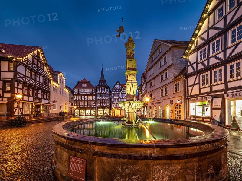 Market square with Roland fountain, cobblestones and half-timbered houses in the historic old town in the evening, Fritzlar, Hesse, Germany