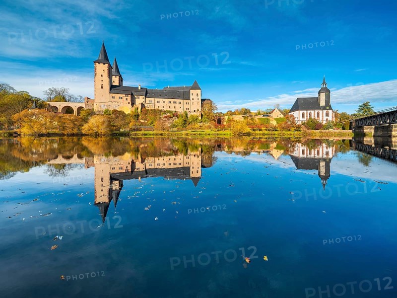 Rochlitz Castle and St. Peter's Church in autumn, perfect reflection in the Zwickauer Mulde river, Rochlitz, Saxony, Germany