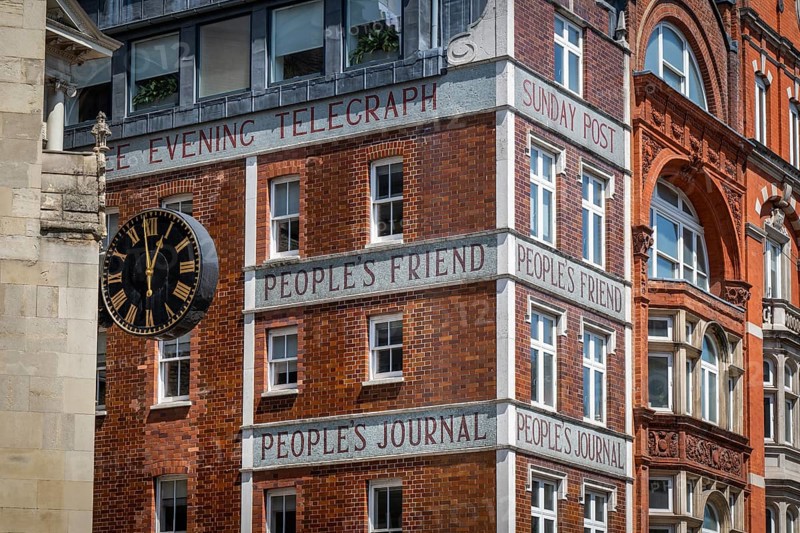 Historic brick building with clock and lettering from newspaper publishers such as Dundee Evening Telegraph, People's Friend, Sunday Post and People's Journal, Fleet Street, former center of the British newspaper industry, London, England, Great Britain